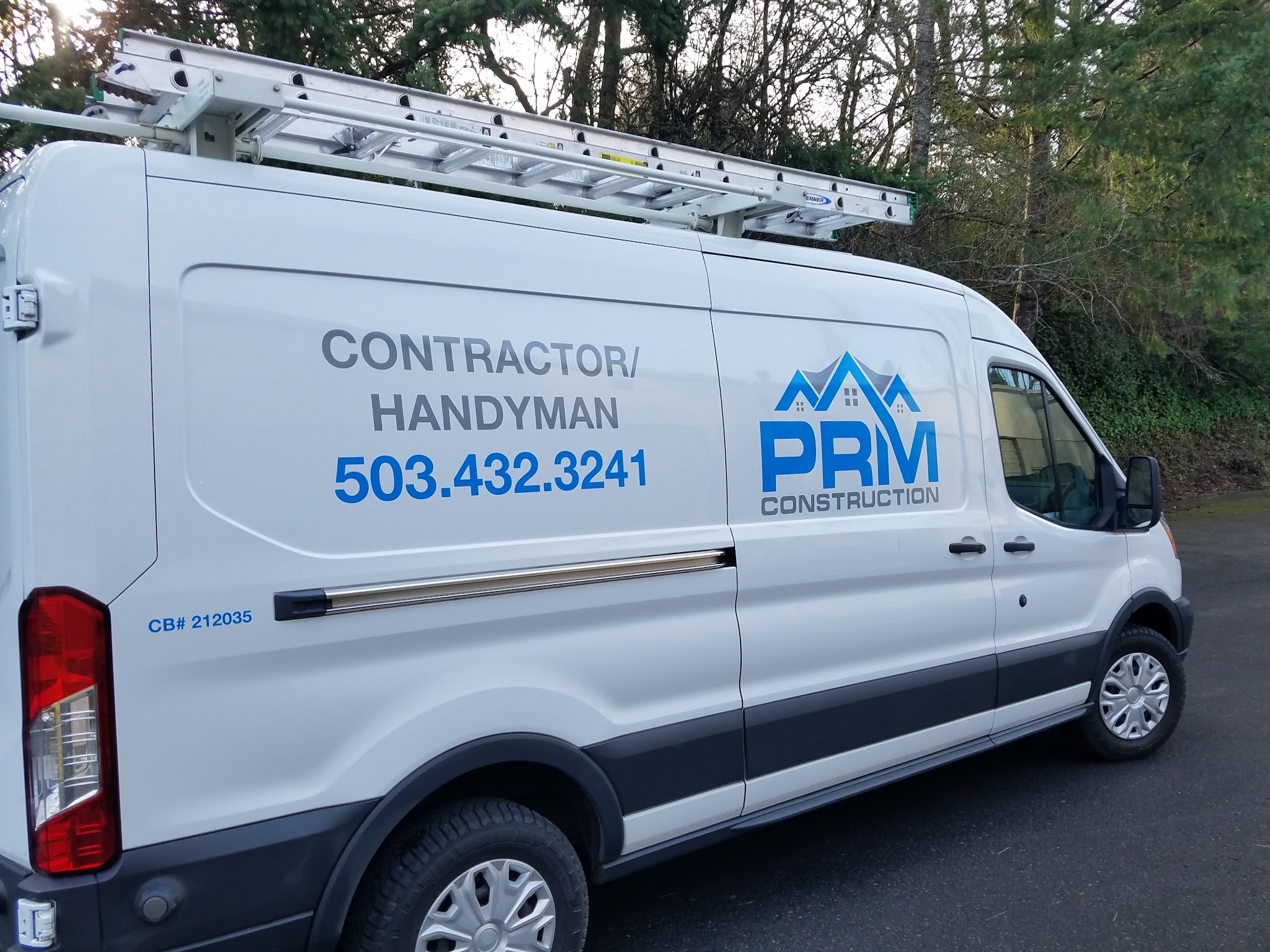Roman's PRM Construction work van, marked with the company name and CCB number