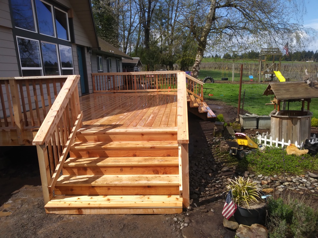 New cedar deck with stairs and railing, freshly built and stained